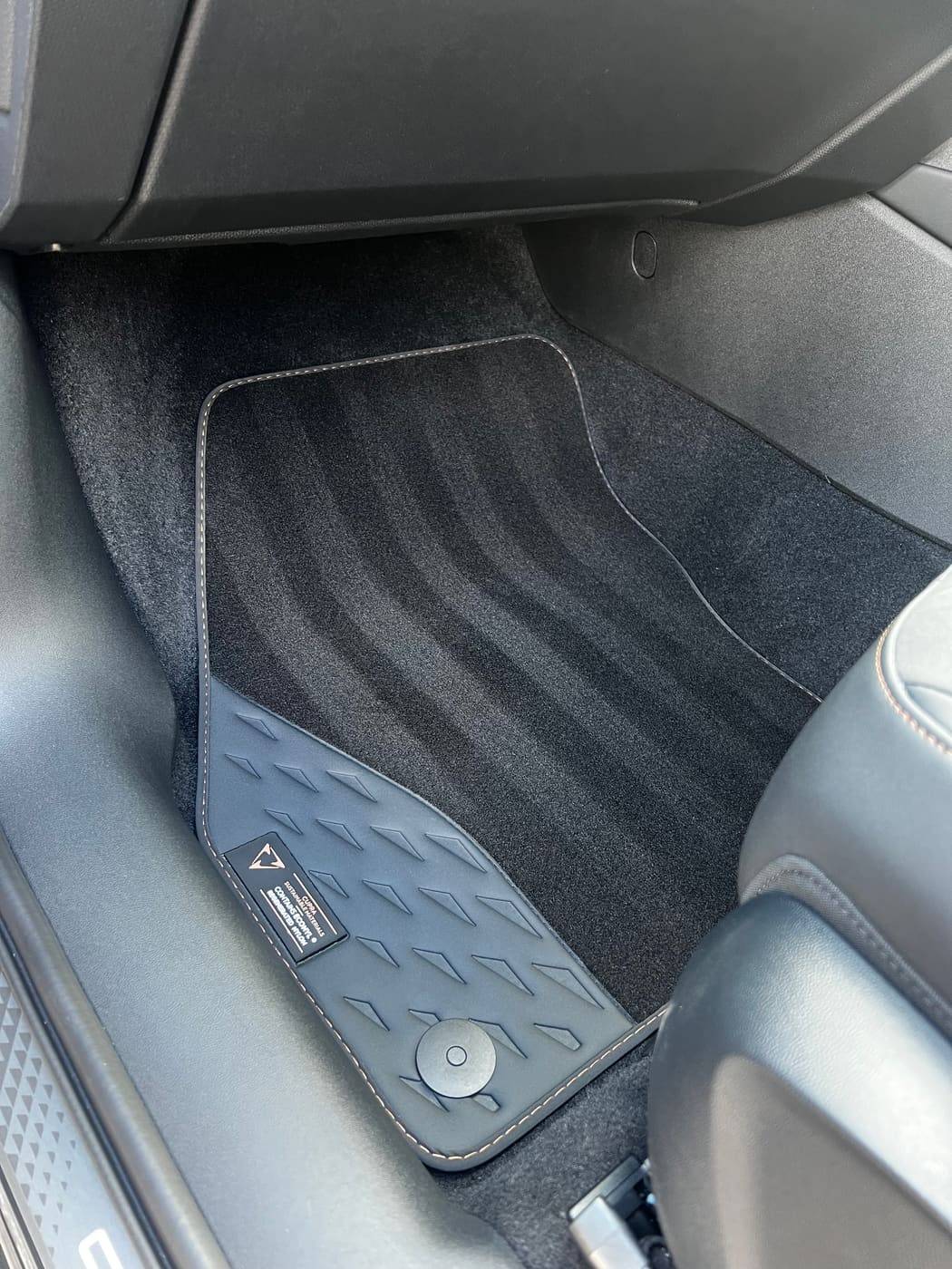 Driver footwell after cleaning, mat lifted and vacuumed