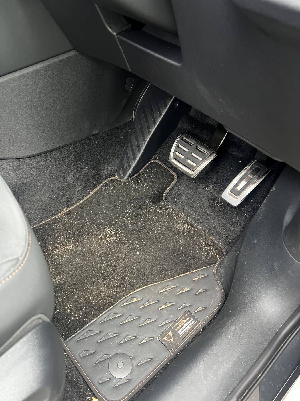 Driver footwell before cleaning, mud ground into the mat