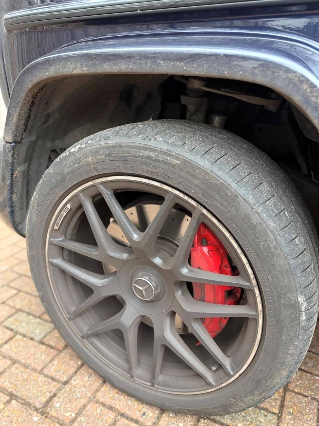 AMG alloy wheel before cleaning, brake dust across the spokes