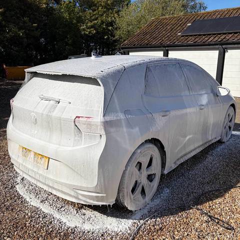 Volkswagen ID.3 covered in snow foam during a wash