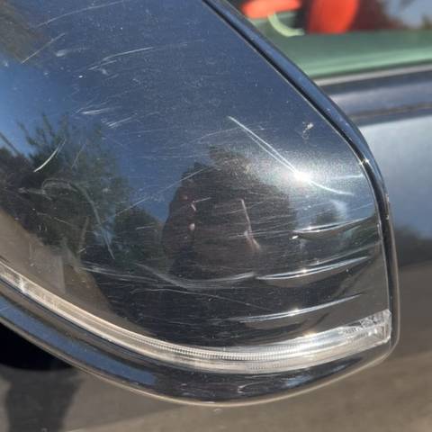Close up of dark car paintwork before machine polishing